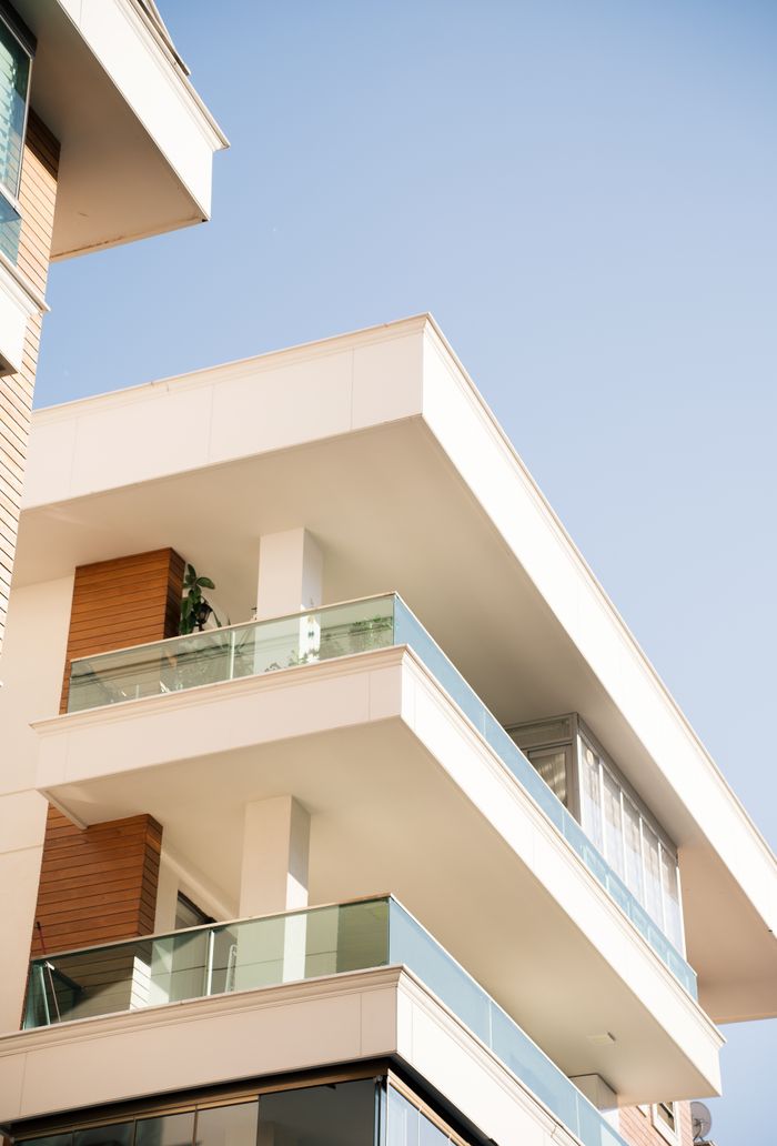 The Art of Drawing Readers In: Your attractive post title goes here Elegant modern building exterior under a clear blue sky.